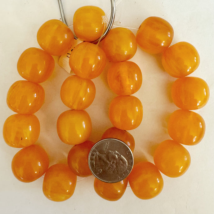 faux amber resin, orange white swirl, 20mm barrel, 11pc strand, sold per strand