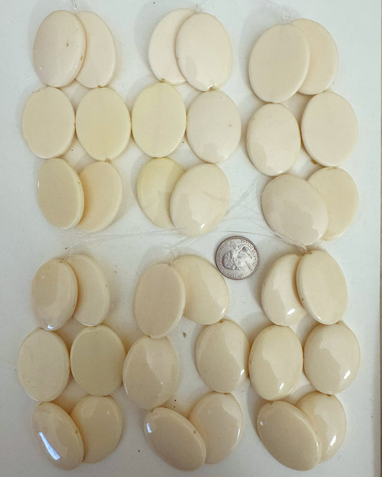 resin,  off white, 39x31x7mm puff oval domed one side flat one side, 2 direction drilled, 6 strand closeout lot