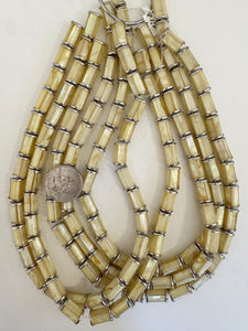 mother of pearl shell sunk in resin, silver plated metal caps, 14x8mm capped tube, 15" strand, sold per strand