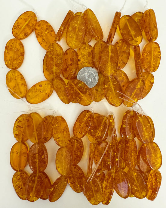 floating pieces motif resin, amber orange, 34x22x7mm oval, 11 strand closeout lot