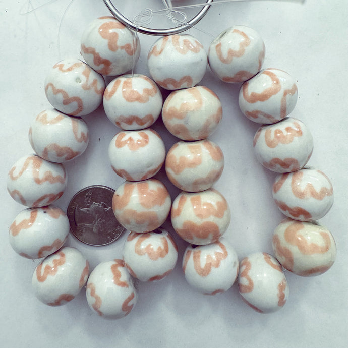 pale peach pink off white, floral motif ceramic, 21x18mm rondelle, 11 piece strand, sold per strand