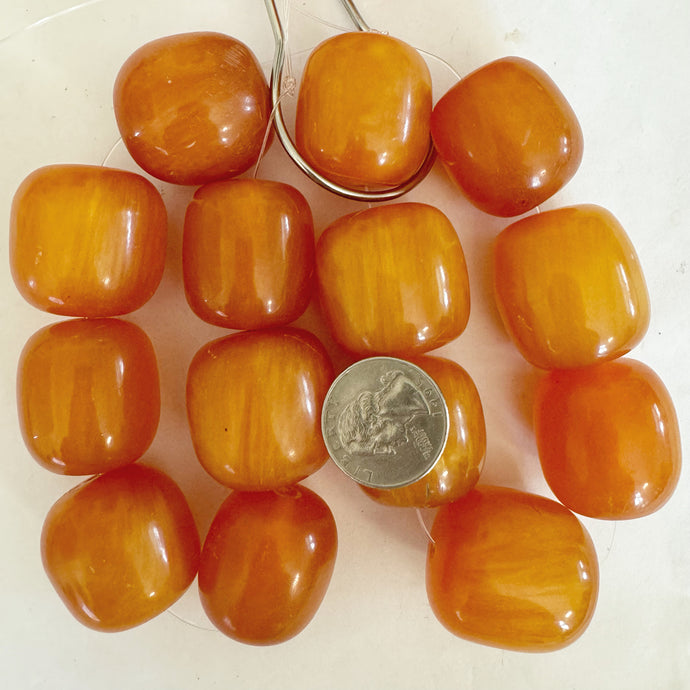 faux amber resin, orange white swirl, 31mm barrel, 7pc strand, sold per strand