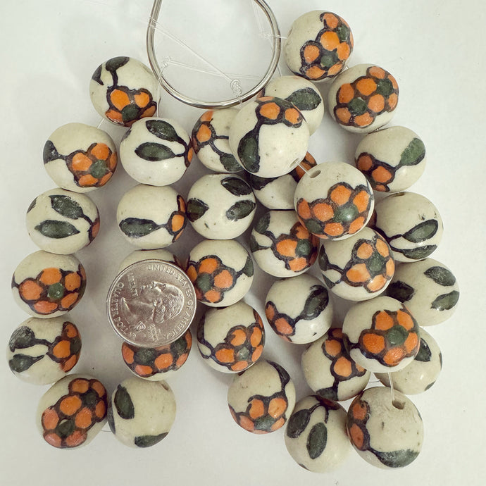 dull finish orange green off white, floral motif ceramic, 20mm irregular round, 11 piece strand, sold per strand