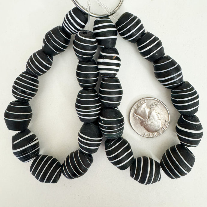 vintage look glass, matte finish, black and white, horizontal stripe motif, 17x14mm barrel mix,  sold per 12pc strand