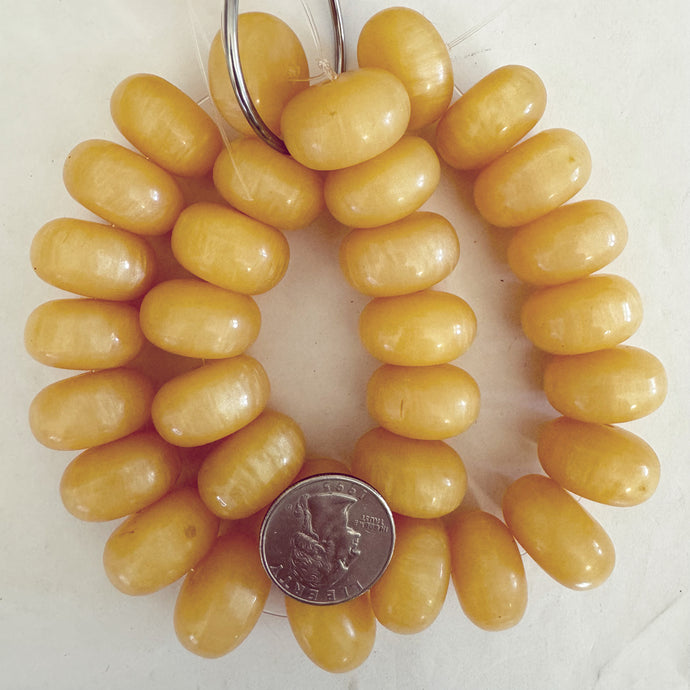 faux amber resin, pale pearly yellow, 22x13mm rondelle, 16pc strand, sold per strand