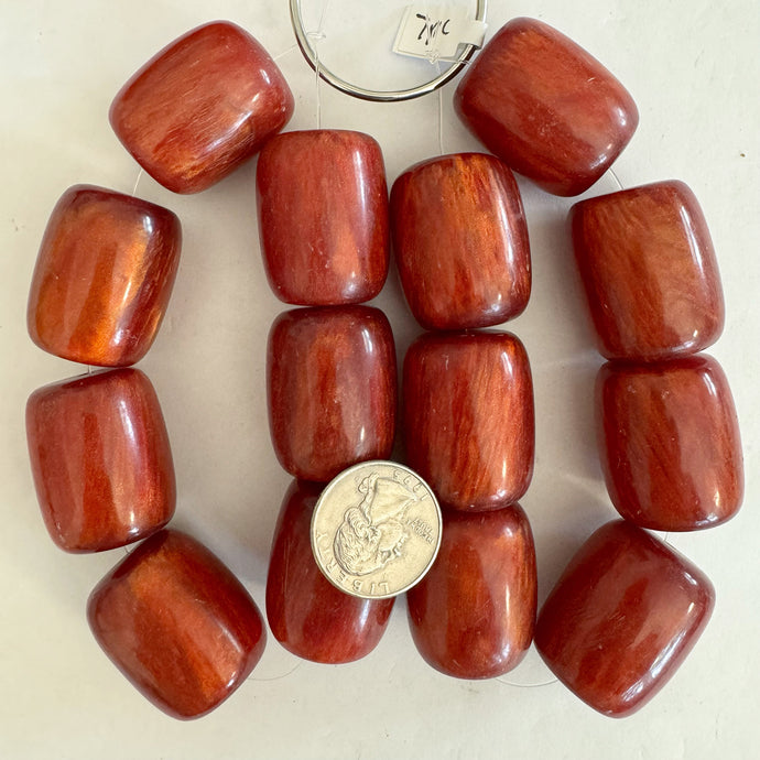 vintage look resin, dark pearly orange red, 32x27mm barrel, 7pc strand, sold per strand