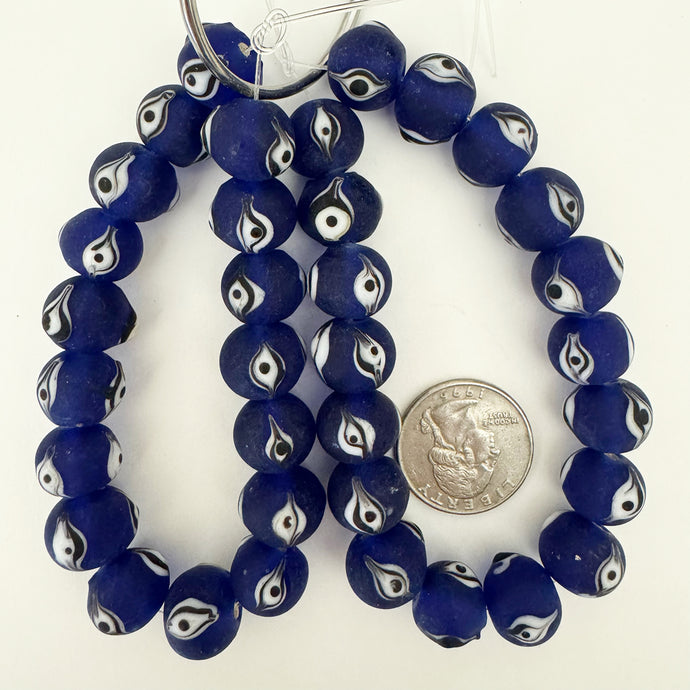 evil eye motif glass, matte finish, cobalt blue black white, 14x11mm mixed size rondelle, 18 piece strand, sold per strand