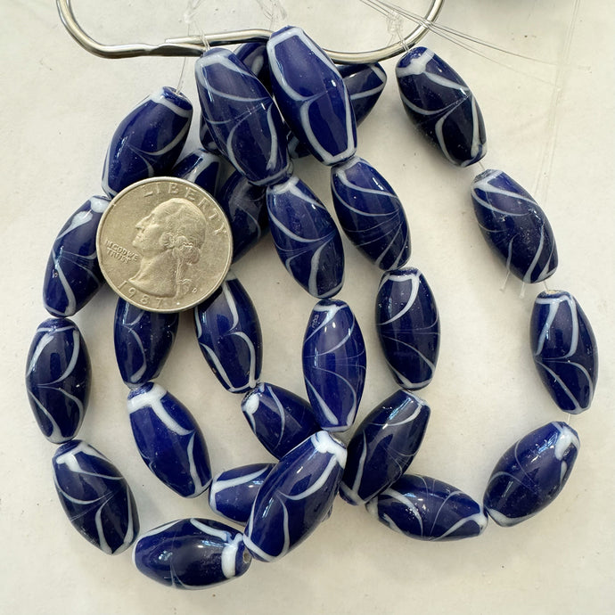 swirling lines motif glass, blue white , 24x12mm bowed tube, 9 piece strand, sold per strand