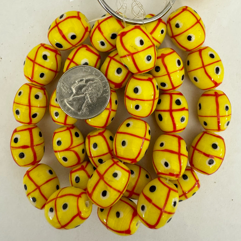 lines dots eyes motif glass, yellow red black white, 20x17mm barrel, 10 piece strand, sold per strand