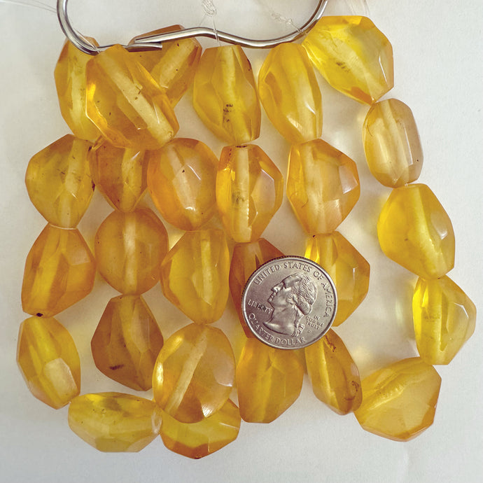 resin, yellow orange, 23-24mm faceted nugget mix, 9pc strand, sold per strand