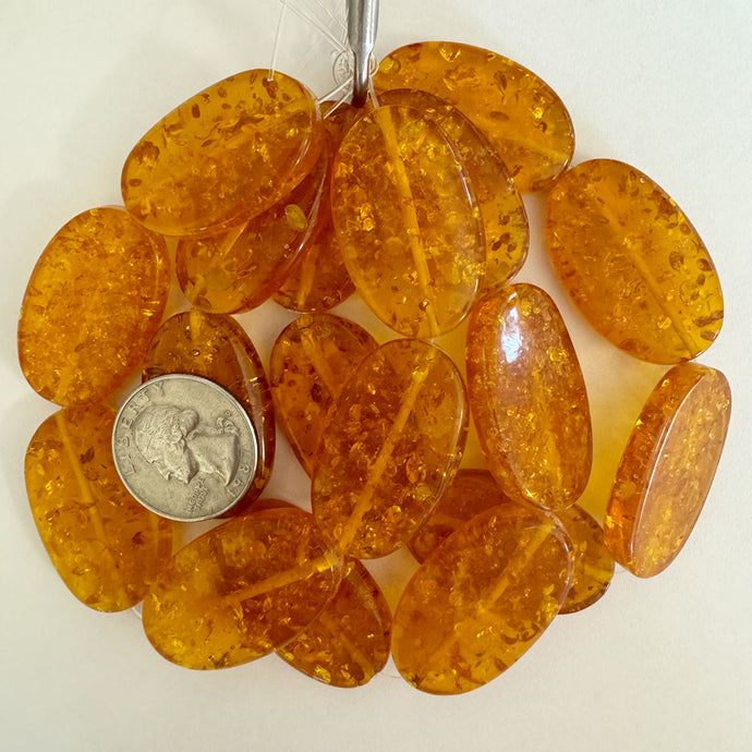 floating pieces motif resin, amber orange, 34x22x7mm oval, 6pc strand, sold per strand