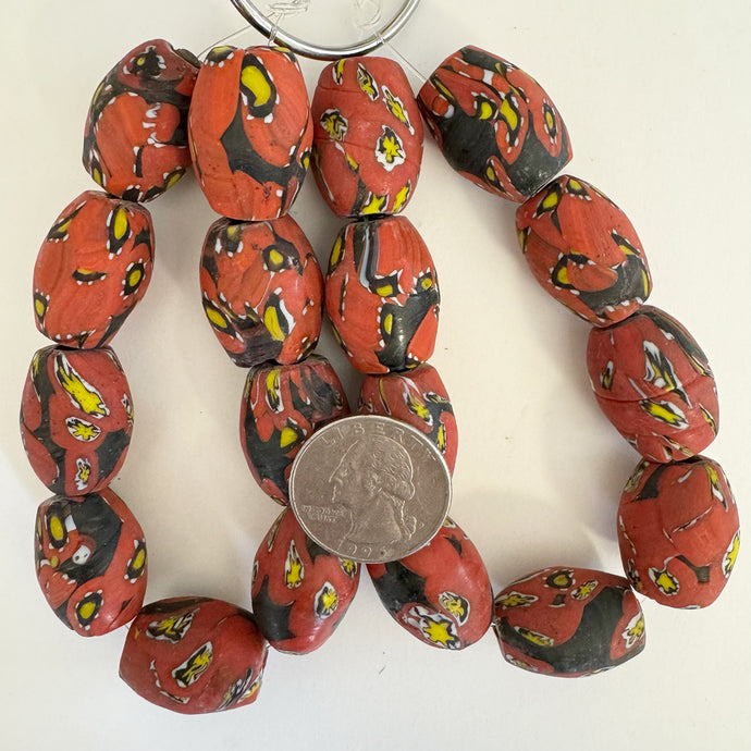 millefiori motif glass, matte black pale orange red yellow, 22x17mm barrel size mix, 9 piece strand, sold per strand