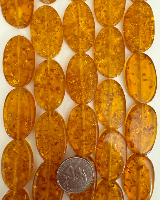 faux amber resin, floating pieces amber orange, 34x22x7mm oval, 15