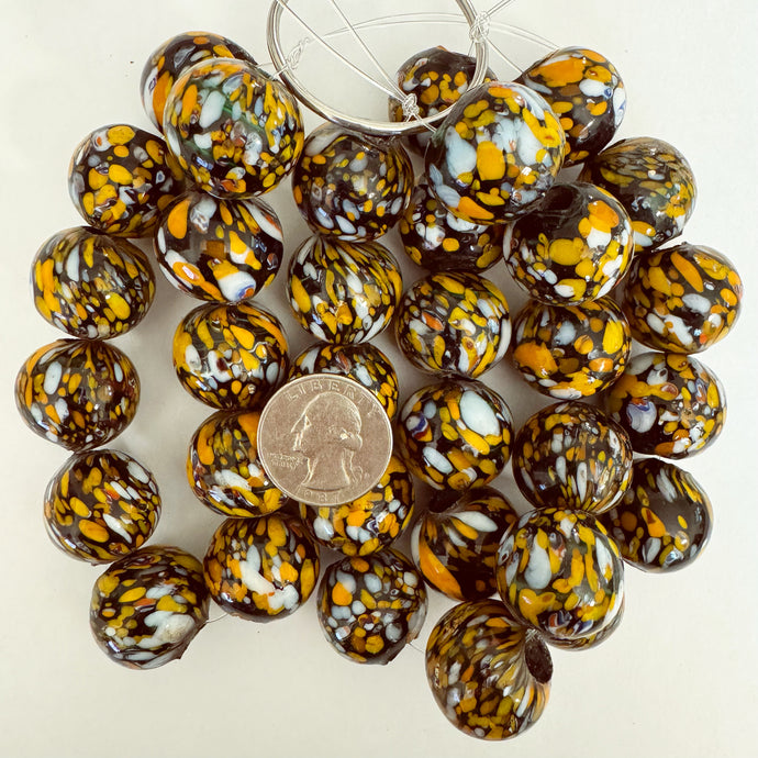 dotted motif glass, dotted white orange over black, 23x22mm roundel, 11 piece strand, sold per strand