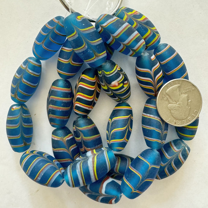 matte feathered lines motif glass, dark electric blue white yellow red, 27x14mm bowed tube, 8 piece strand, sold per strand