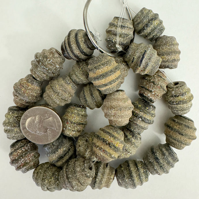 ancient sand grain look motif glass, grainy over dark pale olive green, 18x20mm ridged barrel, 10 piece strand, sold per strand