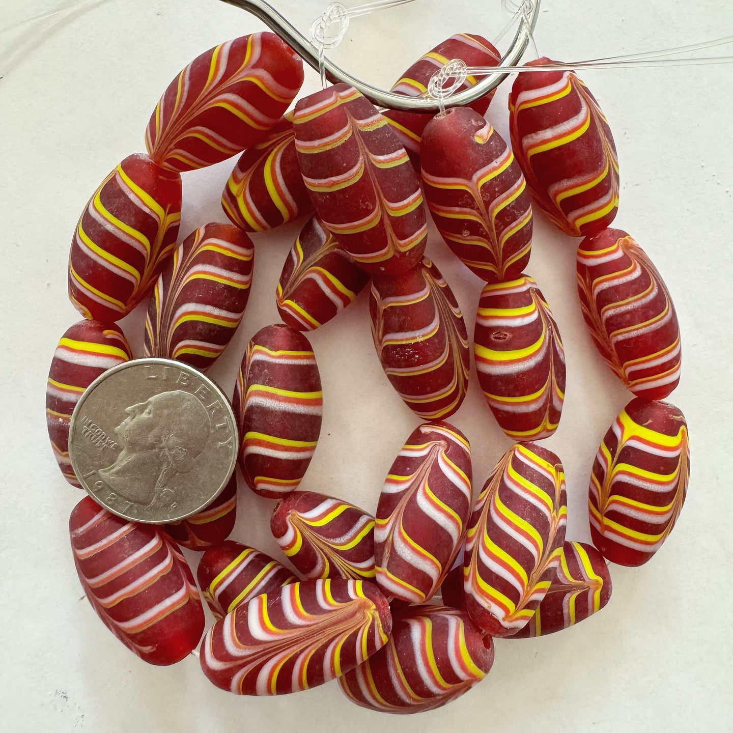 matte feathered lines motif glass, red white yellow , 27x14mm bowed tube, 8 piece strand, sold per strand