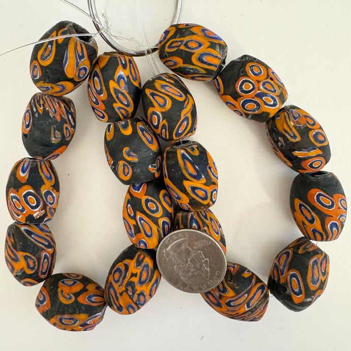 millefiori motif glass, matte black orange blue white, 24x17mm barrel size mix, 9 piece strand, sold per strand