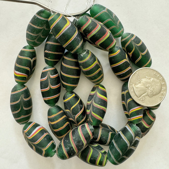 matte feathered lines motif glass, dark green yellow white red, 27x14mm bowed tube, 8 piece strand, sold per strand