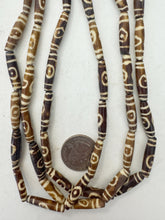 golden brown off white, lines eye motif, vintage stock bone, 24x6mm bowed tube, 15" strand, sold per strand (batch 1)