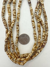 golden brown off white, lines eye motif, vintage stock bone, 24x6mm bowed tube, 15" strand, sold per strand (batch 2)