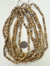 golden brown off white, lines eye motif, vintage stock bone, 24x6mm bowed tube, 15" strand, sold per strand (batch 2)