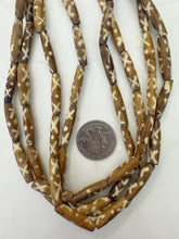 golden brown off white, x dot motif, vintage stock bone, 24x6mm bowed tube, 15" strand, sold per strand