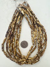 golden brown off white, x dot motif, vintage stock bone, 24x6mm bowed tube, 15" strand, sold per strand