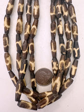 dark brown off white, swirl line motif, vintage stock bone, 23x7mm pointed tube filed bottom, 15" strand, sold per strand