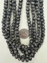 dull black off white, carved eye motif, vintage stock bone, 9x6mm rondelle, 15" strand, sold per strand