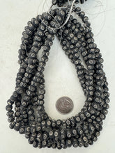 dull black off white, carved eye motif, vintage stock bone, 9x6mm rondelle, 15" strand, sold per strand