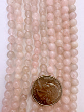 variable tone rose quartz, 6-7mm round, 15" strand,  SOLD PER STRAND