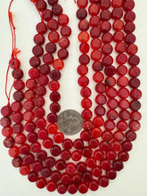 lighter and darker bright red color enhanced quartz, 10x10x6mm coin, 15" strand, sold per strand