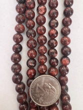 color enhanced serpentine: very dark red orange, 8mm round, 15" strand,  SOLD PER STRAND