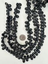 black stone, 17x13x7mm faceted flat oval, 15" strand, sold per strand