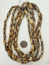 brown off white, dot zig zag lines motif, vintage stock bone, 18x7mm bowed tube, 15" strand, SOLD PER STRAND