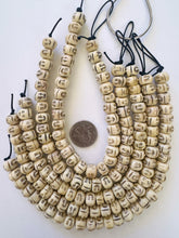 off white brown black, carved faces motif, vintage stock bone, 12x7mm rondelle, 11" strand, SOLD PER STRAND