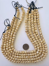 off white red brown, carved eye motif, vintage stock bone, 10x7mm rondelle, 15" strand, SOLD PER STRAND