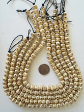 off white, carved sarburst lines motif, vintage stock bone, 10x8mm rondelle, 15" strand,  SOLD PER STRAND