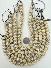 off white black, carved eye motif, vintage stock bone, 15x11mm rondelle, 12.5" strand, SOLD PER STRAND