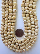 off white red brown, carved eye motif, vintage stock bone, 10x7mm rondelle, 15" strand, SOLD PER STRAND