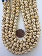 off white browm, carved spiral lines motif, vintage stock bone, 11x8mm rondelle, 15" strand, SOLD PER STRAND