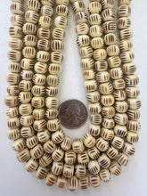 off white black, carved parallel lines motif, vintage stock bone, 11x8mm rondelle, 15" strand, SOLD PER STRAND