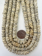 off white black, carved dot greek key motif, vintage stock bone, 8x6mm rondelle, 15" strand, SOLD PER STRAND