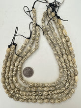 carved crossing lines motif, vintage stock bone, 12x9mm barrel,  16" strands,  SOLD PER STRAND