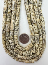 off white brown black, carved line eye motif, vintage stock bone, 21x7mm tube, 15" strand, SOLD PER STRAND