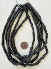 dark brown, carved lines motif, vintage stock bone, 25x6mm pointed tube, 15" strand, SOLD PER STRAND