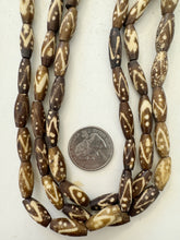 brown off white, dot zig zag lines motif, vintage stock bone, 18x7mm bowed tube, 15" strand, SOLD PER STRAND