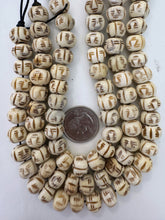 off white brown, carved face motif, vintage stock bone, 12x9mm rondelle, 11" strand, SOLD PER STRAND