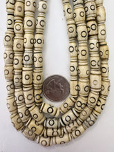 off white brown black, carved circle line motif, vintage stock bone, 13x8mm barrel, 15" strand, SOLD PER STRAND